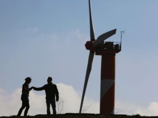 An Israeli couple visits the wind farm on Mount Bnei Rasan overlooking the border with Syria on Nov. 27, 2009, in the Golan Heights. The 10 wind turbines produce 6 megawatts of electricity which is used by local industry and the residents of the disputed plateau that Israel captured from Syria in the 1967 Six Day War. (David Silverman/Getty Images)