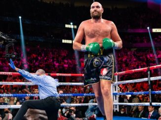 WBC heavyweight champion Tyson Fury (center) floors Deontay Wilder for the third and final time on Saturday as referee Russell Mora signals his 11th-round knockout in Saturday's bout in Las Vegas. (Ryan Hafey/Premier Boxing Champions) 