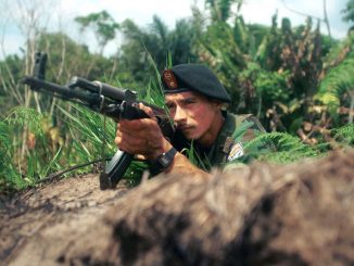 A member of the FARC protects a road close to Bogotá, Sumapaz, Colombia, on March 7, 2002. The Peace Agreement with these guerilla fighters was signed on November 24, 2016, but Colombians have not forgotten the pain of years of kidnapping and rapes by the armed outfit formed in 1964. (Photo by Carlos Villalon/Getty Images)