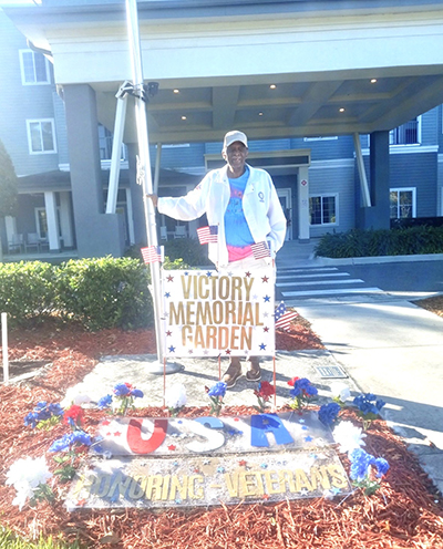 Fred Beneby proudly stands beside his special project at Seagrass Village in PORT ORANGE, FL